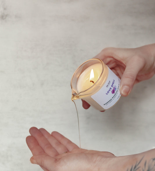 A romantic massage candle being poured into the palm of a hand